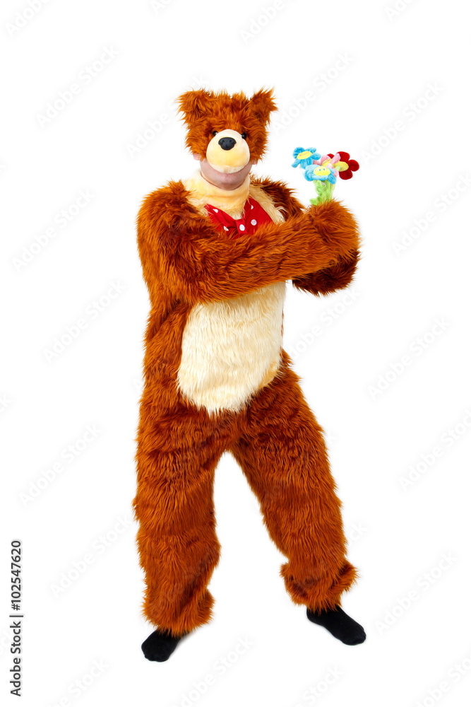 Humorous bear with toy flowers on white background Humorous bear with toy flowers on white background