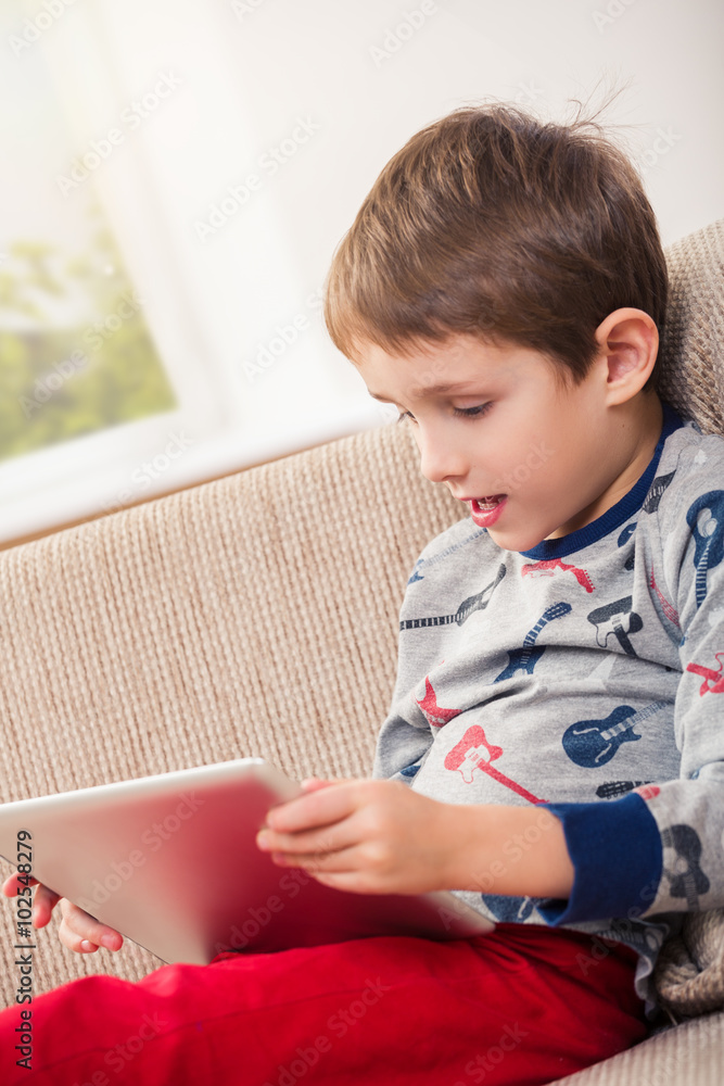 boy playing with digital tablet boy playing with digital tablet