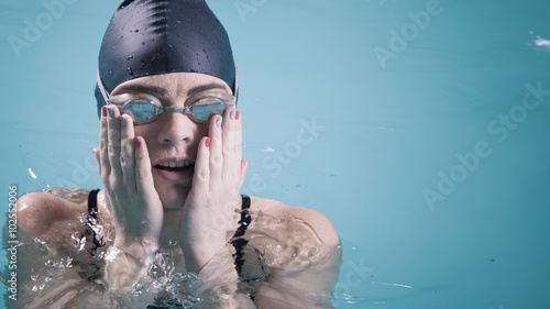 Woman athlete in swimming pool water. Sport.