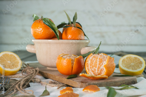 Mandarins and lemon on wooden table