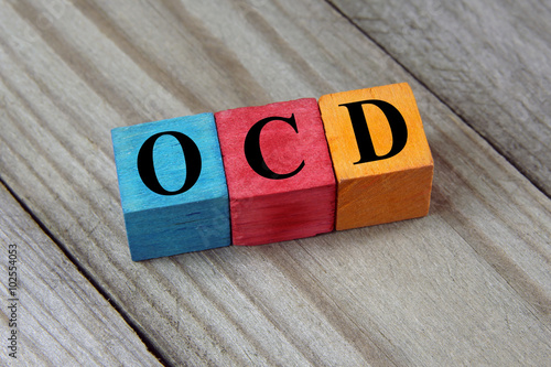 OCD (Obsessive Compulsive Disorder) text on colorful wooden cube photo