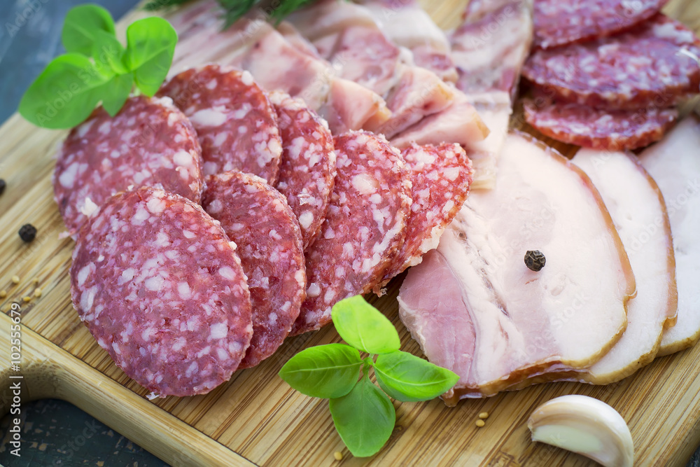 Slices of salami and bacon, selective focus Slices of salami and bacon, selective focus
