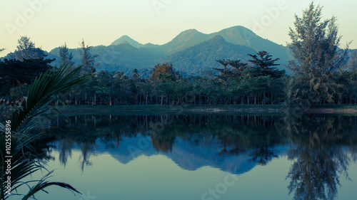 Landscape of mountains reflected in the water of the lake, Koh Chang island, Thailand. photo