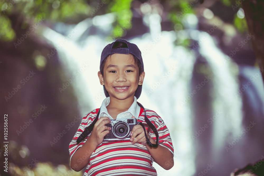 Asian boy photographer with camera 