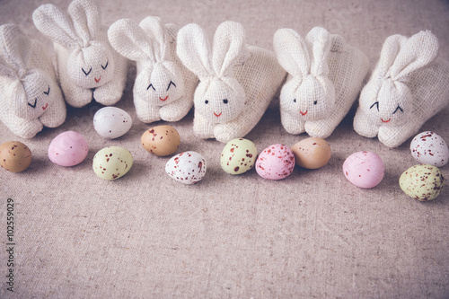 Easter pastel speckled eggs and bunny, selective copy space background