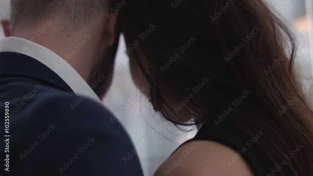 Happy young couple enjoying an intimate moment, laughing a lot and man gently strokes his partner's hair Happy young couple enjoying an intimate moment, laughing a lot and man gently strokes his partner's hair