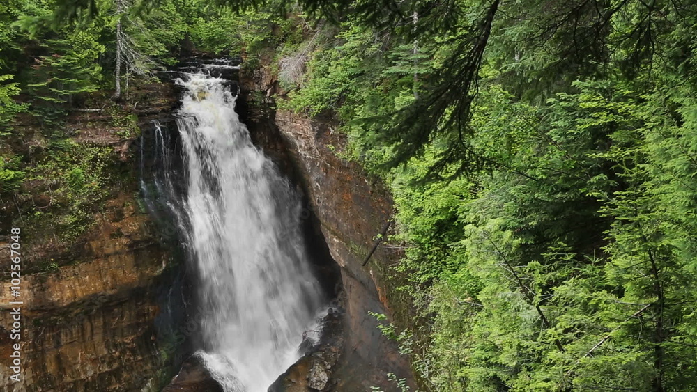 Seamless loop features Upper Peninsula Michigan's Miners Falls, a powerful tall waterfall in the woods of Pictured Rocks National Lakeshore.