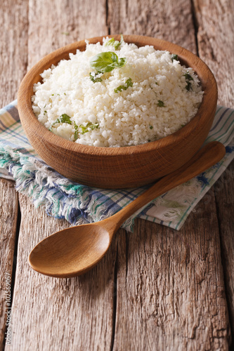 Paleo Food: Cauliflower rice with herbs close-up. Vertical
