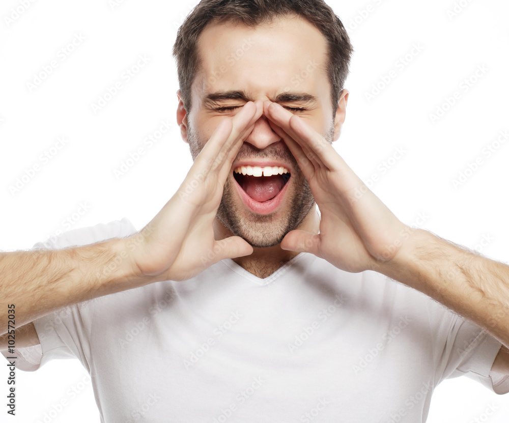 man in t-shirt shouting while looking at camera man in t-shirt shouting while looking at camera