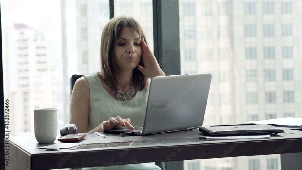 Tired businesswoman with laptop having headache in office
Tired businesswoman with laptop having headache in office