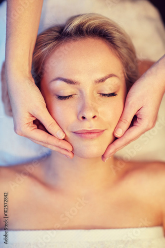 close up of woman having face massage in spa