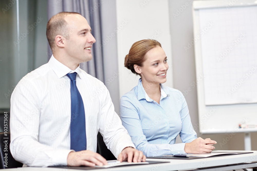 group of smiling businesspeople meeting in office group of smiling businesspeople meeting in office