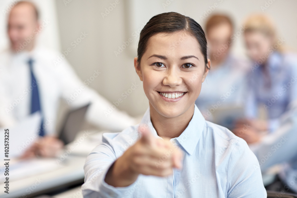 group of smiling businesspeople meeting in office group of smiling businesspeople meeting in office