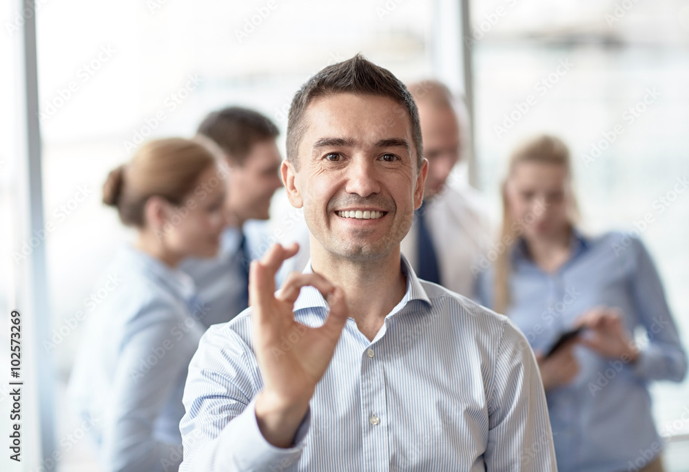 group of smiling businesspeople meeting in office group of smiling businesspeople meeting in office