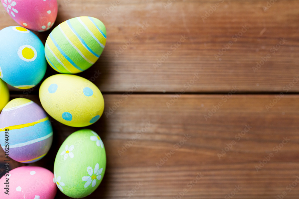 close up of colored easter eggs on wooden surface close up of colored easter eggs on wooden surface