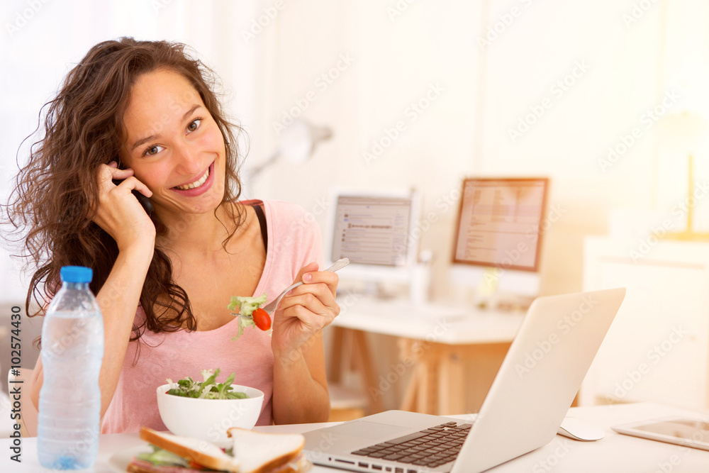 Young attractive student eating while working Young attractive student eating while working
