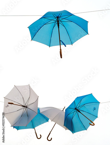 White and blue umbrellas hanging in the sky