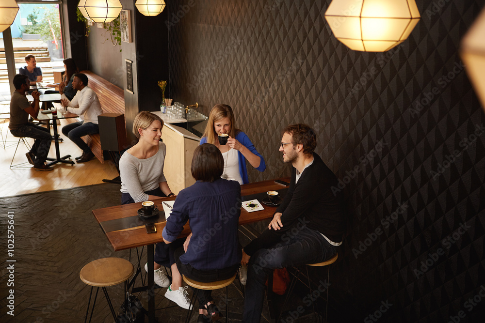 Fototapeta premium Group of friends meeting for cappucinos in a coffee shop
