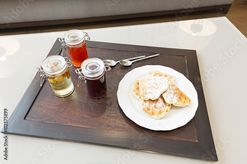 Hotel breakfast served on wooden tray photo