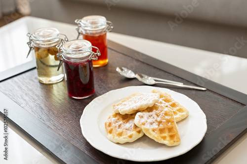 Hotel breakfast served on wooden tray photo