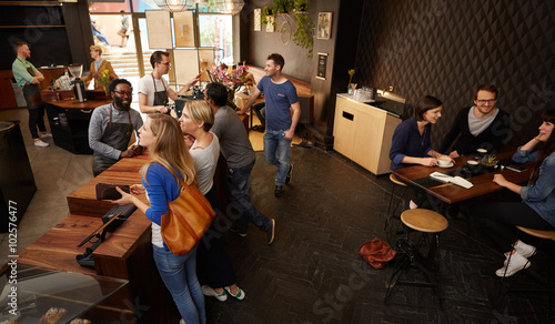 Spacious and modern coffee shop with smiling customers