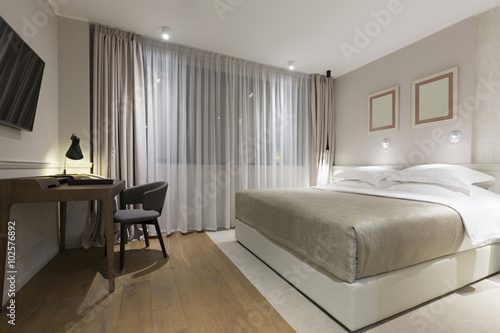 Interior of a luxury hotel bedroom in the evening © rilueda