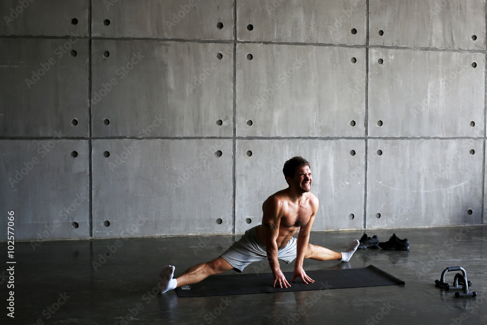 Naklejka premium Man on the Mat practicing yoga and fitness