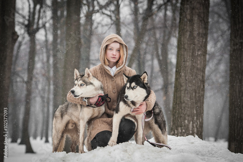 A teen girl with two husky dogs  © k2foto