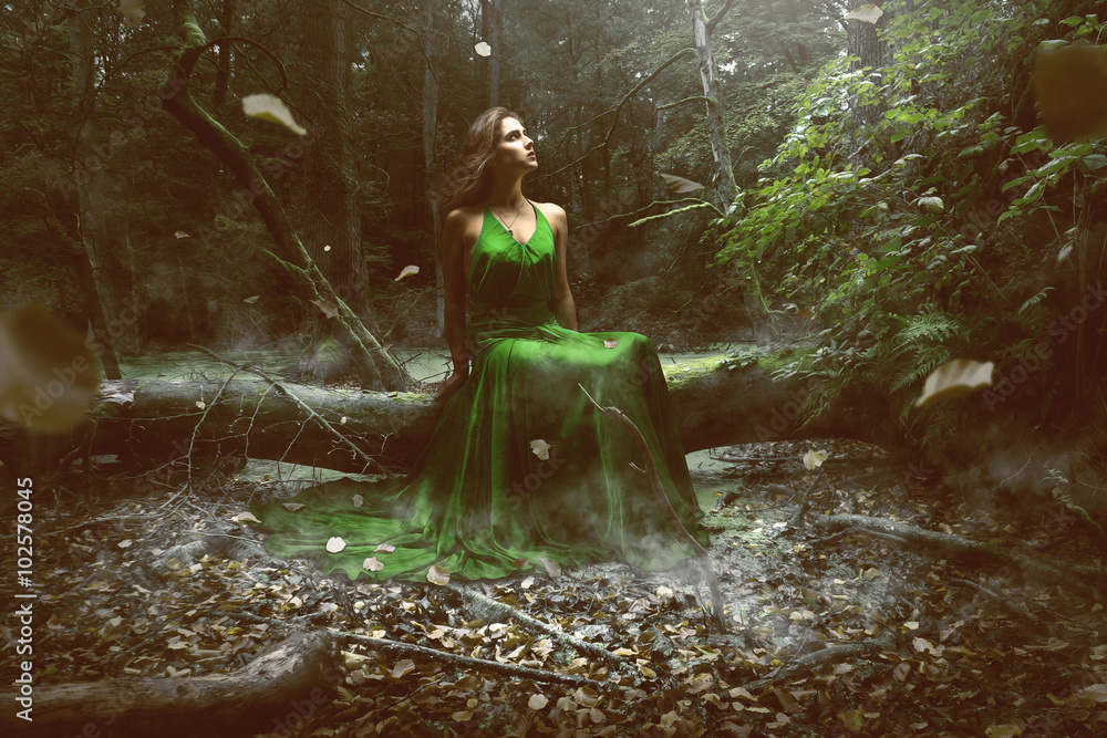 Woman wears a green dress in the forest - obrazy, fototapety, plakaty 