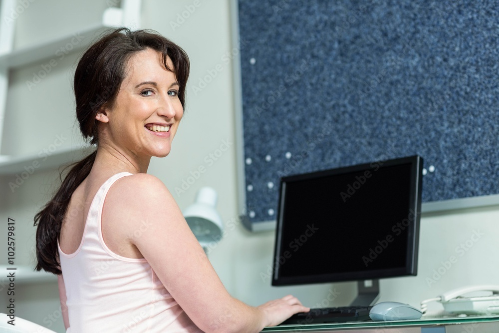 Pregnant woman on her computer Pregnant woman on her computer