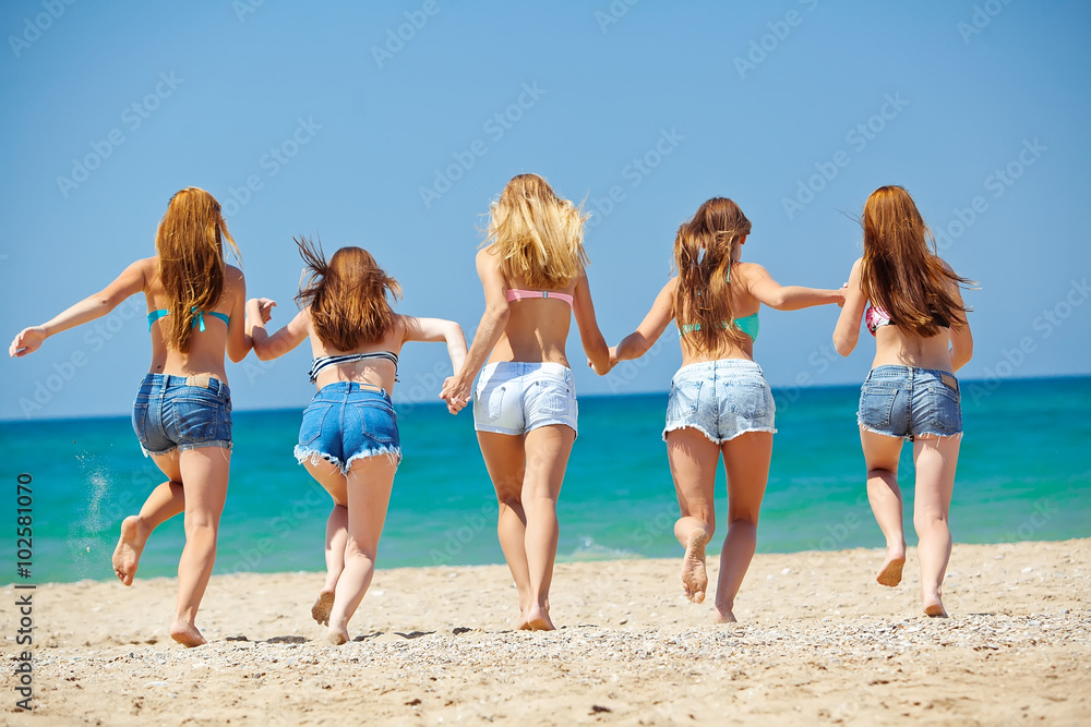 Group of relaxing teenager people on the beach Group of relaxing teenager people on the beach