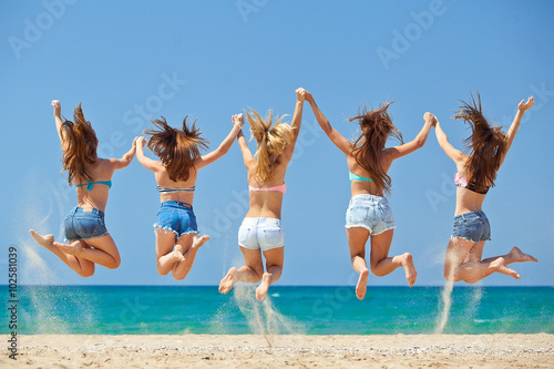 Group of relaxing teenager people on the beach photo