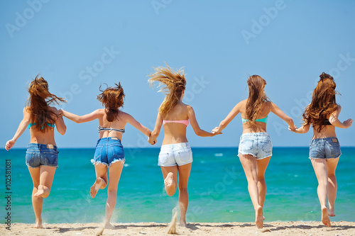 Group of relaxing teenager people on the beach