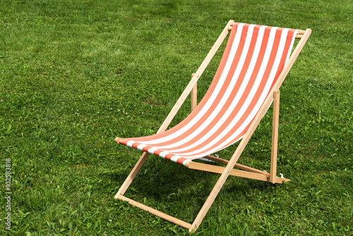 Vászonkép Deck-chair on grass