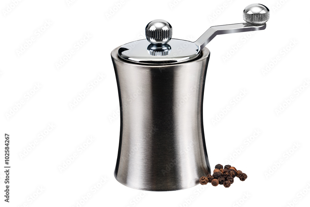 Metal pepper mill and a few grains on a white background Metal pepper mill and a few grains on a white background