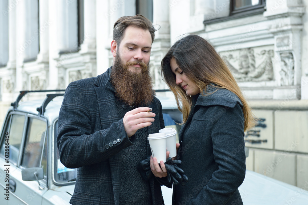 Autumn outdoor fashion portrait of young couple drinking coffee Autumn outdoor fashion portrait of young couple drinking coffee