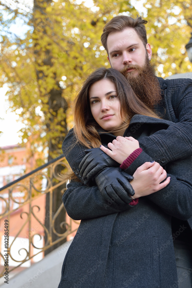 Fototapeta premium Autumn outdoor portrait of young heterosexual couple.