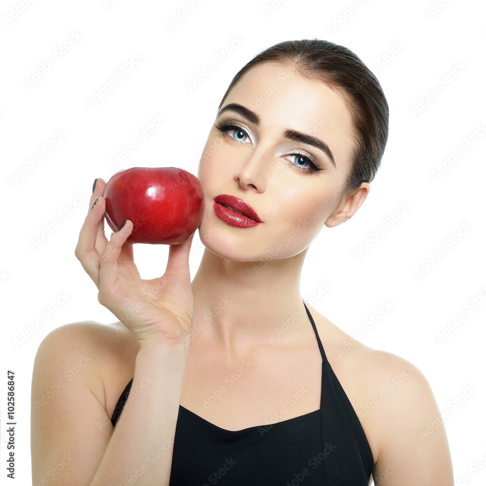 Portrait of beautiful young woman holding red apple near her fac Portrait of beautiful young woman holding red apple near her fac