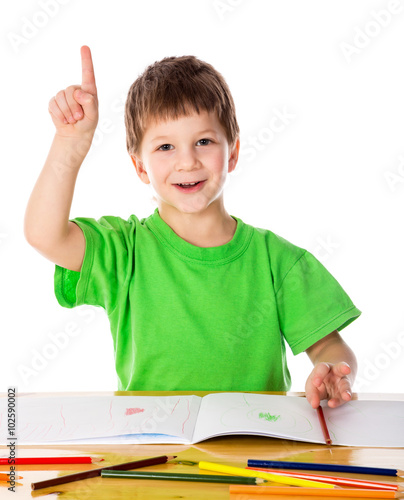 Creative little boy at the table