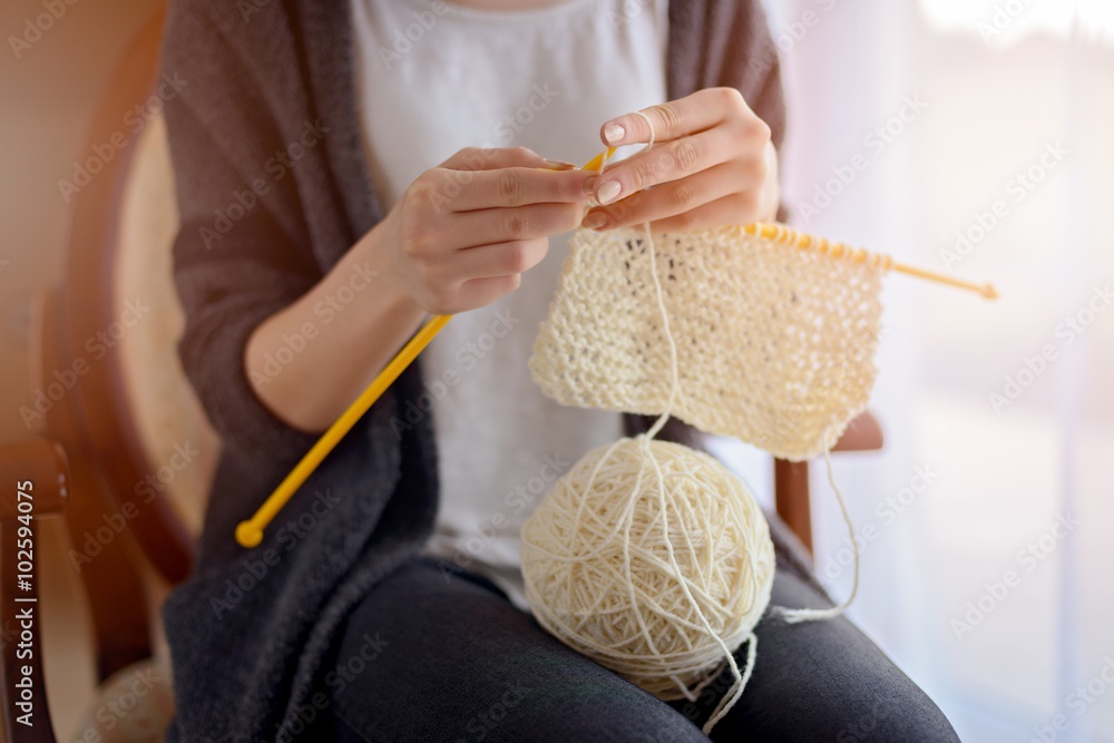 Close up on woman's hands knitting