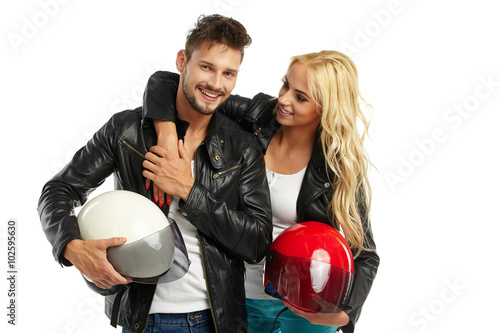motorcyclists couple with helmets in hand