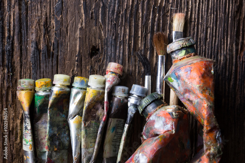 Vintage stylized photo of oil multicolor paint tubes closeup and