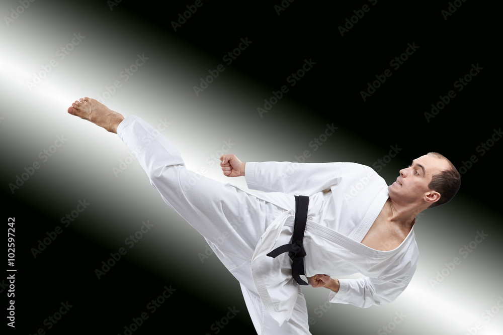 The athlete beats a kick on the gradient background The athlete beats a kick on the gradient background