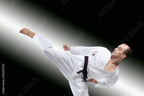 The athlete beats a kick on the gradient background
