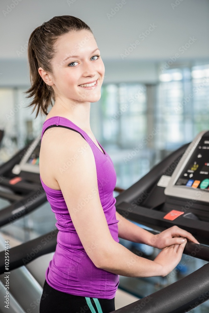 Smiling brunette on treadmill