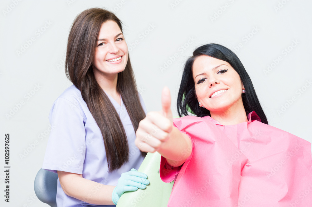 Satisfied woman client at dentist showing like Satisfied woman client at dentist showing like
