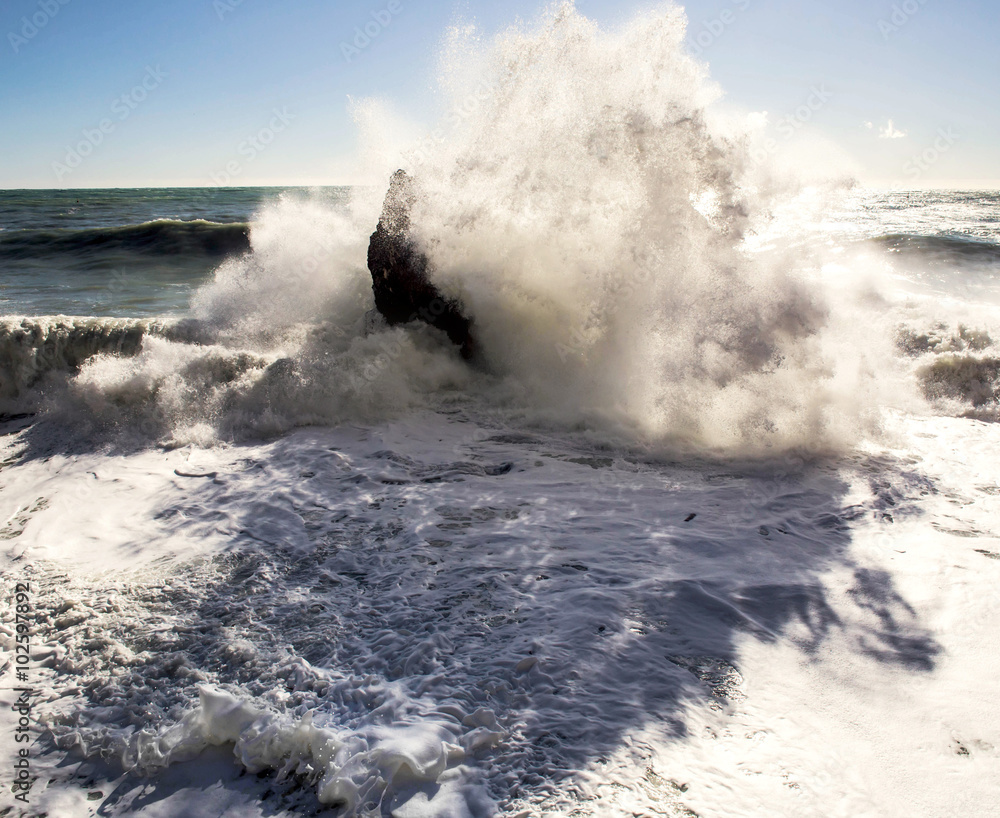 big wave breaking over rocks