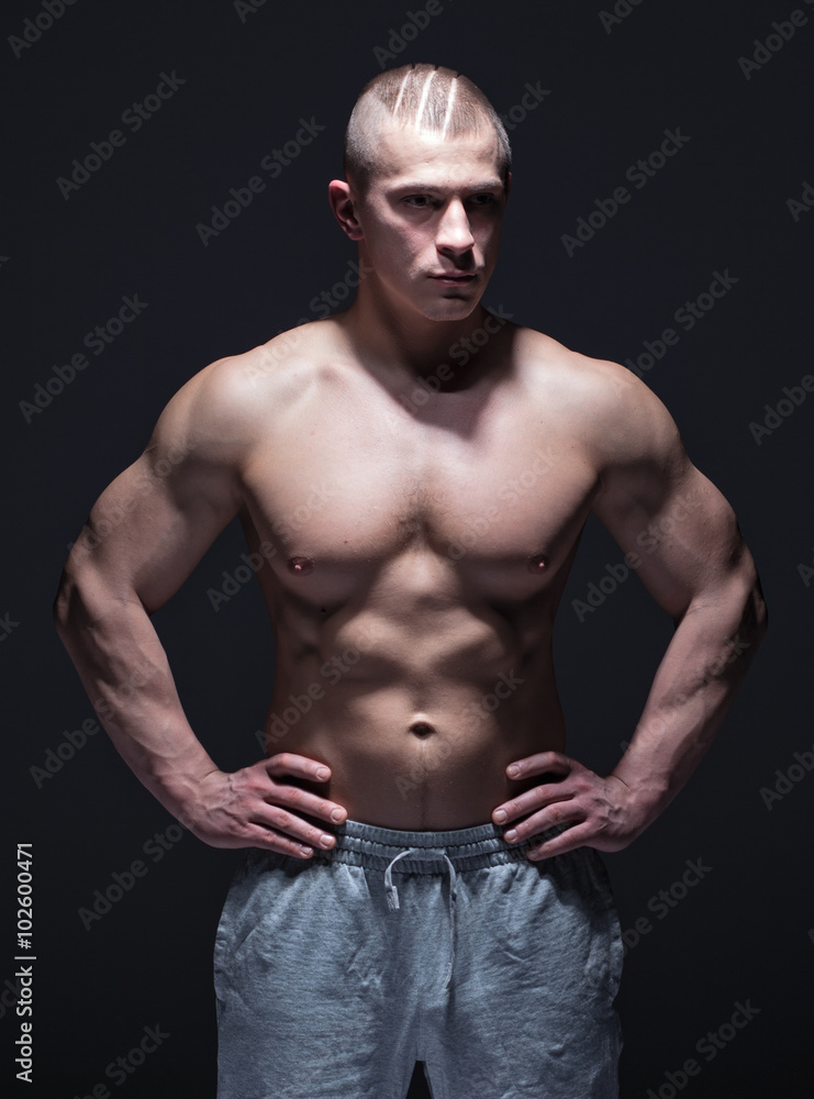 sportsman with muscular torso in dark space sportsman with muscular torso in dark space