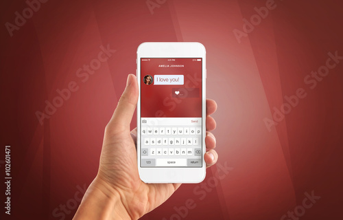 I love you message on smart phone display. Phohe in woman hand with red background. photo