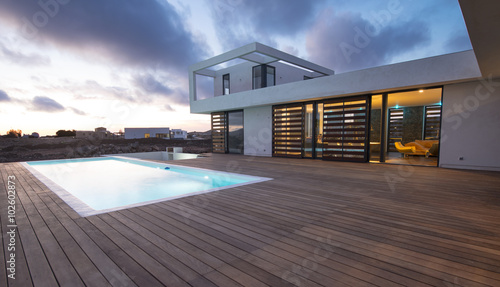 Luxury modern home with backyard swimming pool photo